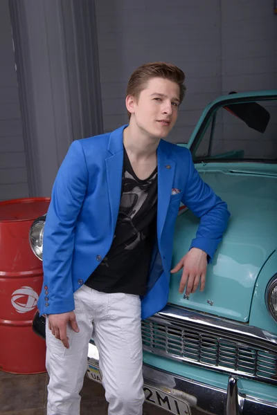 Portrait of a young man in the car garage — Stock Photo, Image