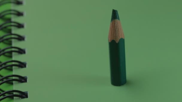 Small Sharpened Green Wooden Pencil Appears Stands Green Notebook Video — Stock Video