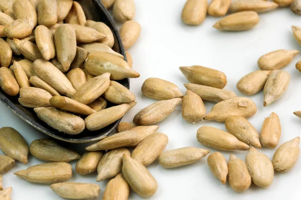 Kavrulmuş ayçiçeği tohumları çay kaşığında yakın plan beyaz bir aynada.