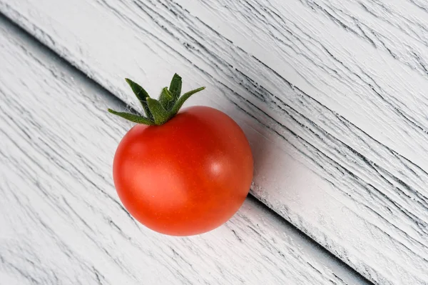 Small Red Ripe Tomato White Textured Wooden Background Close — ストック写真