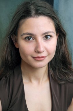 Açık kahverengi iç çamaşırlı, uzun dalgalı saçlı güzel bir kızın portresi.