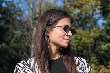 Young tall girl with long dark straight hair in summer leopard costume