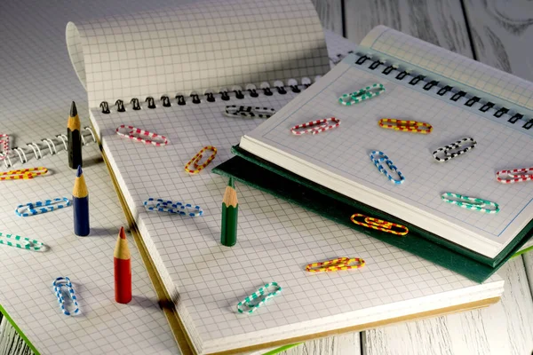 Opened Blank Notepads Checkered Loose Leaf Papers Pencils Paper Clips — Stock Photo, Image
