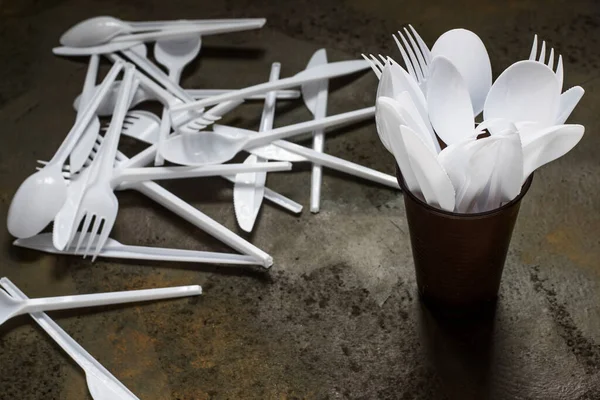 plastic disposable cutlery in plastic cup
