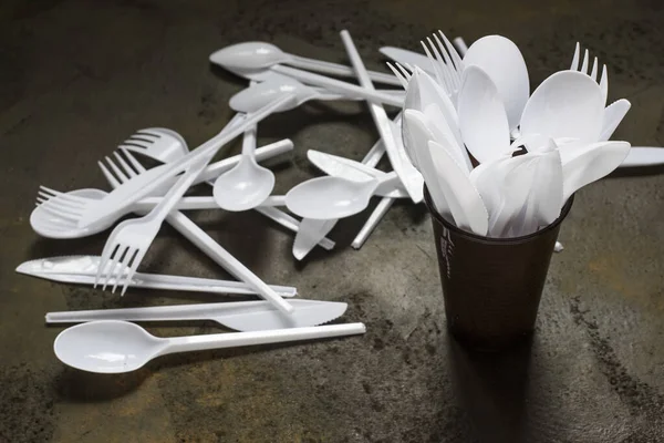 plastic disposable cutlery in plastic cup