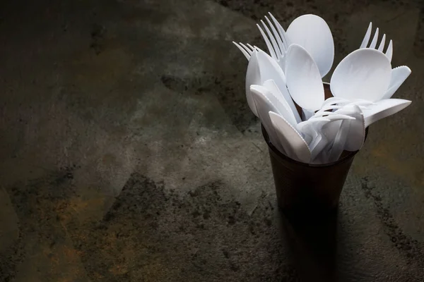 plastic disposable cutlery in plastic cup