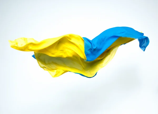 Absztrakt darab repülő kék és sárga szövet — Stock Fotó