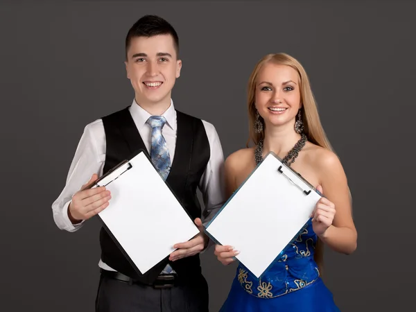 Young man and woman holding clip boards — Stock Photo, Image