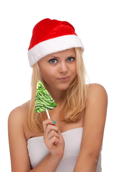 Junge blonde Frau mit Weihnachtsmann-Hut und Süßigkeiten — Stockfoto