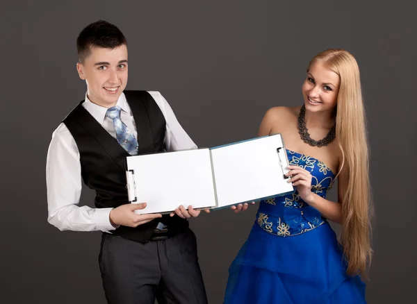 Young man and woman holding clip boards — Stock Photo, Image