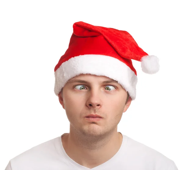 Young man in santa hat with crossed eyes — Stock Photo, Image