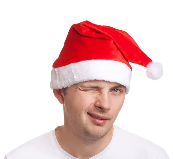 Young man in santa hat winking — Stock Photo, Image