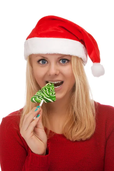 Junge blonde Frau mit Weihnachtsmann-Hut und Süßigkeiten — Stockfoto