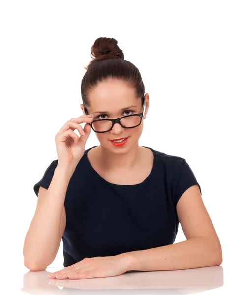 Portrait of woman looking over glasses — Stock Photo, Image