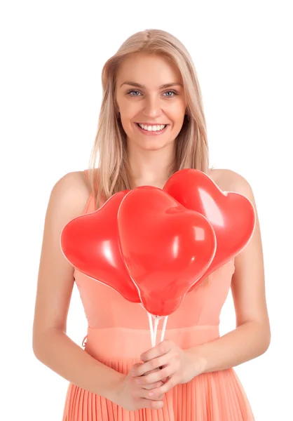 Giovane donna con palloncini a forma di cuore — Foto Stock