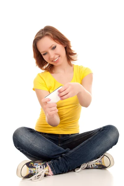 Young woman playing games on smartphone — Stock Photo, Image