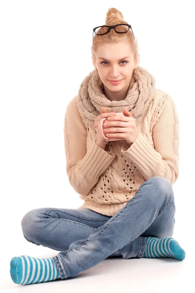 Blond woman holding cup of hot drink — Stock Photo, Image