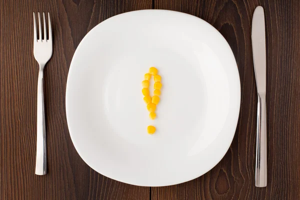 Exclamation mark made of corn seeds on a plate — Stock Photo, Image