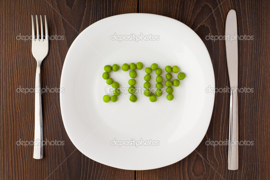 Word stop made of peas on a plate