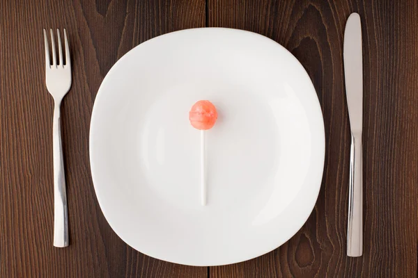 Lillipop on a white plate — Stock Photo, Image