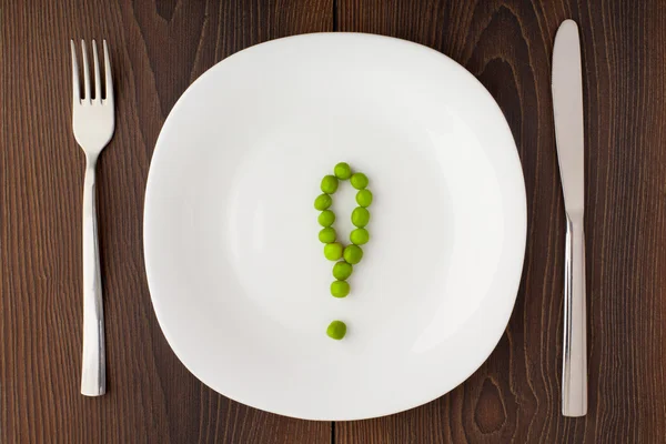 Exclamation mark made of peas on a plate — Stock Photo, Image