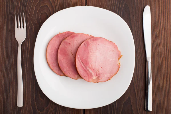 Slices of delicious ham on plate — Stock Photo, Image