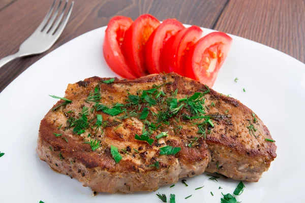 Grilled steak on white plate — Stock Photo, Image