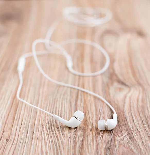 Audio earphones on a table — Stock Photo, Image