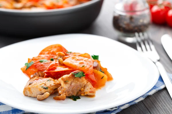 Fried pork with pan-roasted tomatoes Stock Picture