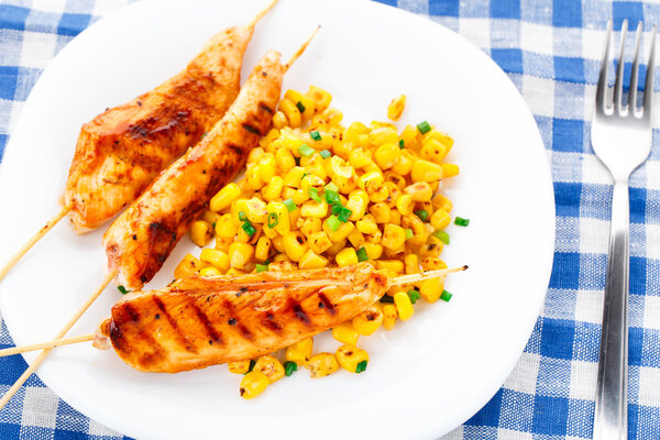 Honey chicken skewers with grilled corn salad