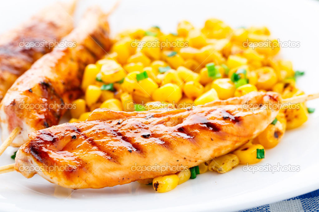 Honey chicken skewers with grilled corn salad