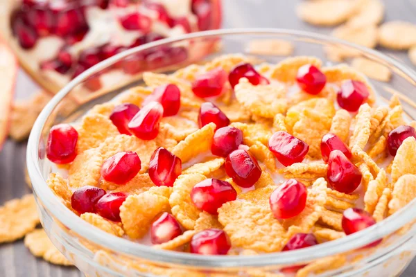 Sugar coated corn flakes with milk and pomegranate — Stock Photo, Image