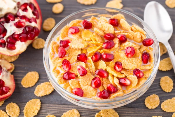 Sugar coated corn flakes with milk and pomegranate — Stock Photo, Image