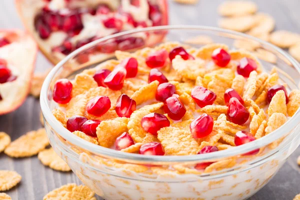 Sugar coated corn flakes with milk and pomegranate — Stock Photo, Image