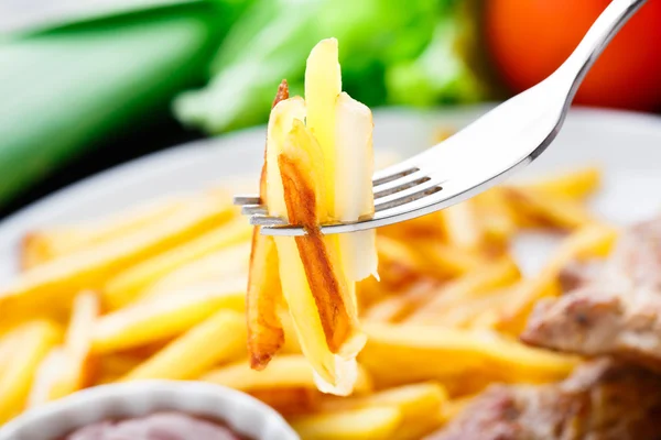 French fries on a fork — Stock Photo, Image