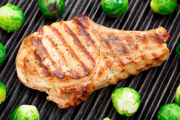 Grilled pork chop with brussels sprouts — Stock Photo, Image