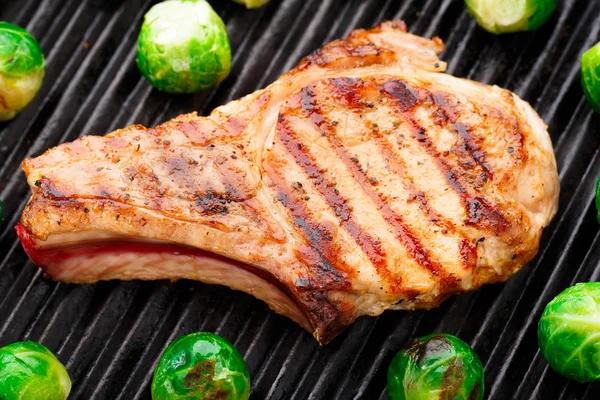 Grilled pork chop with brussels sprouts — Stock Photo, Image