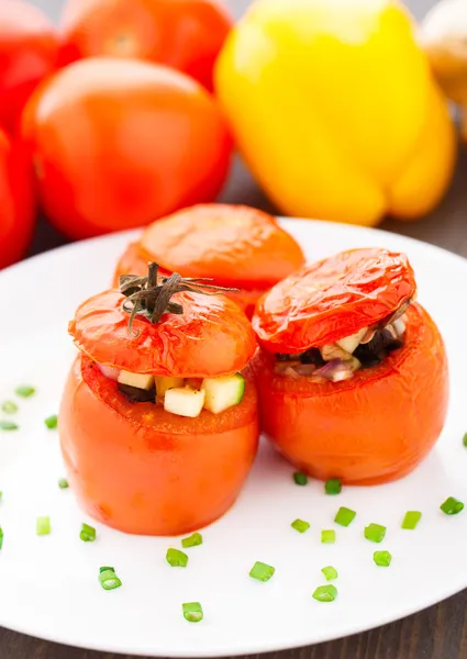 Three stuffed tomatoes on a white plate — Stock Photo, Image