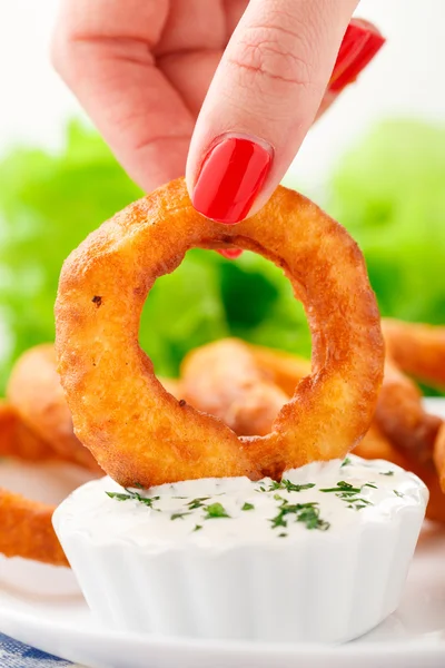 Fingers holding onion ring — Stock Photo, Image