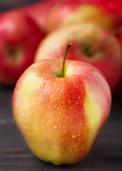 Red apples on wooden table — Stock Photo, Image