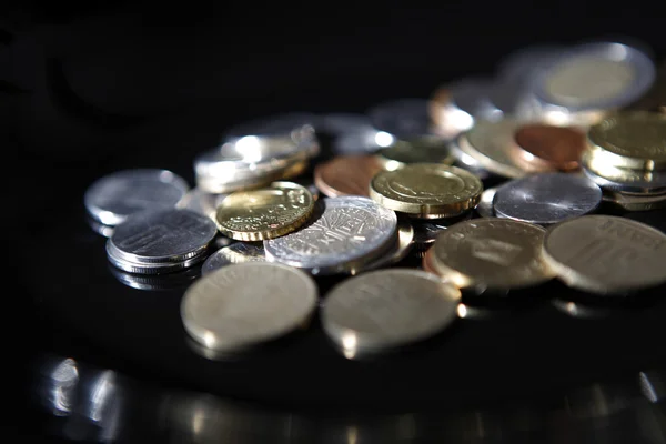 Coins on black — Stock Photo, Image