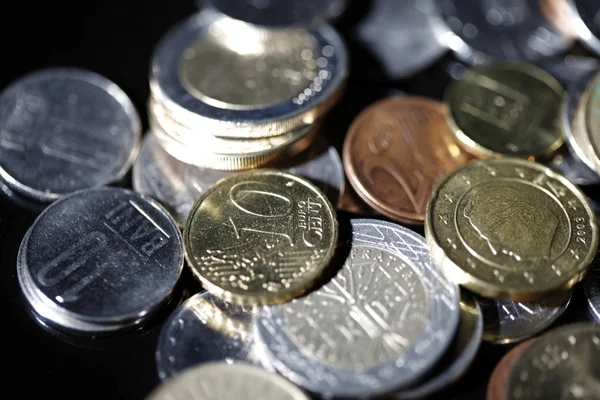 Coins on black — Stock Photo, Image