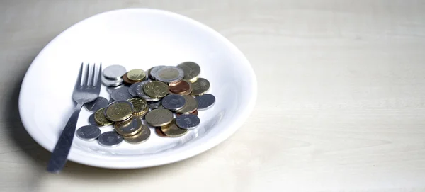 Coins on a plate — Stock Photo, Image