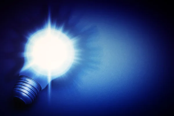 Background with lit lightbulb — Stock Photo, Image