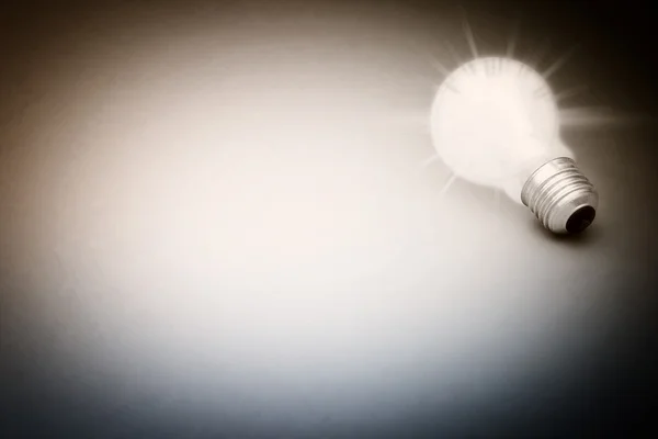 Background with lit lightbulb — Stock Photo, Image