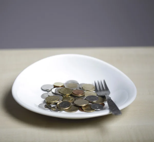 Coins on a plate — Stock Photo, Image