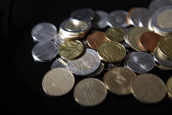 Coins on black — Stock Photo, Image