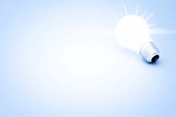 Background with lit lightbulb — Stock Photo, Image