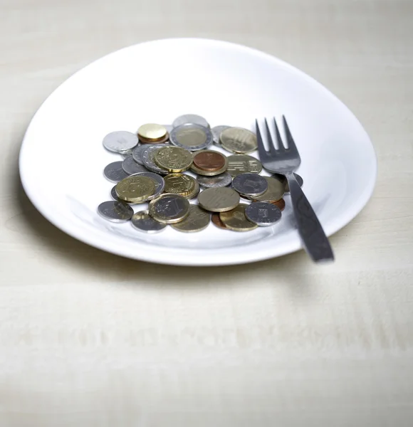 Coins on a plate — Stock Photo, Image