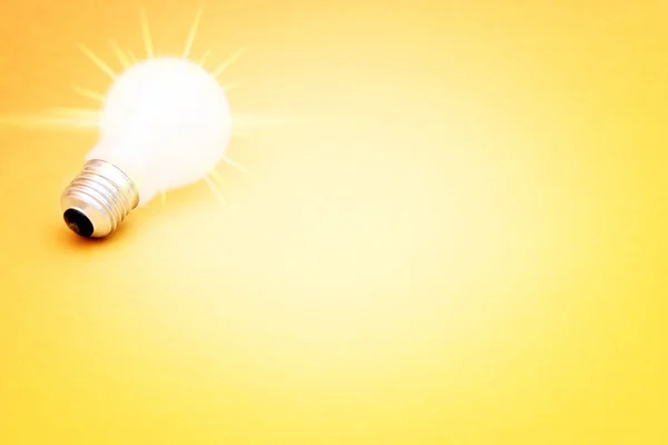 Background with lit lightbulb — Stock Photo, Image